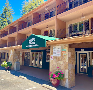 Brookdale Lodge reception area with green awning, stone pillars, and balconies